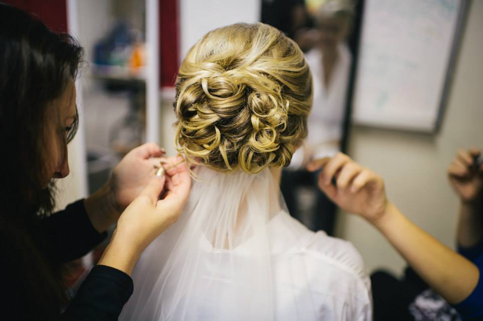 A bride getting the back of her hair done