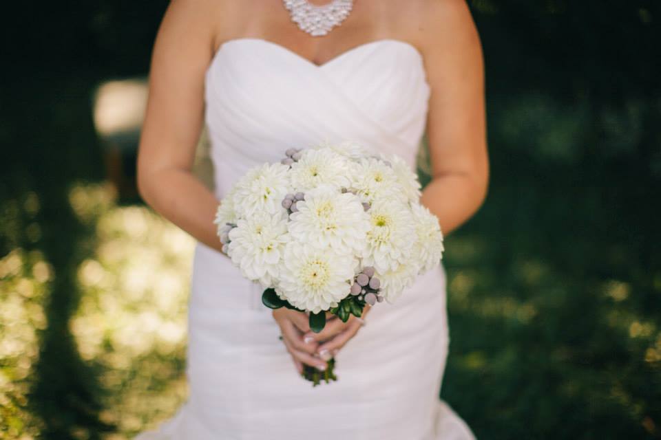 A closeup of a bride's white floral bouquet 